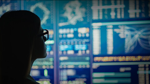Woman viewing Network Operations Center monitors