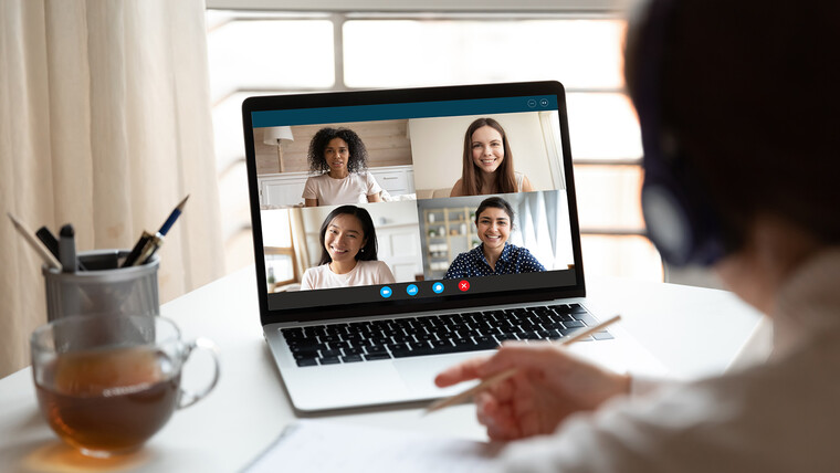 A laptop showing four users in a video call