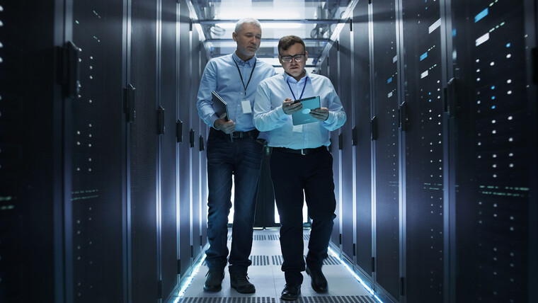 Two men standing in server room